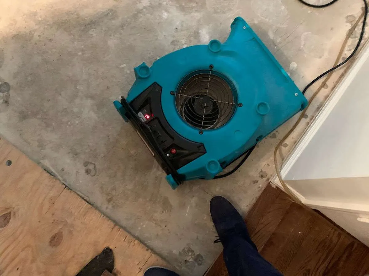 Air mover drying subfloor during Commercial Water Damage Restoration in Sheffield Lake